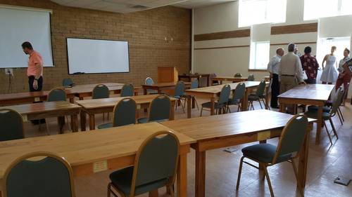 <p>Each table in this classroom is built from a different type of wood.</p>
